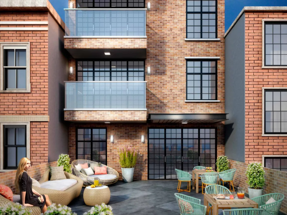 Terrace with large aluminum-framed sliding patio panels behind outdoor furniture.
