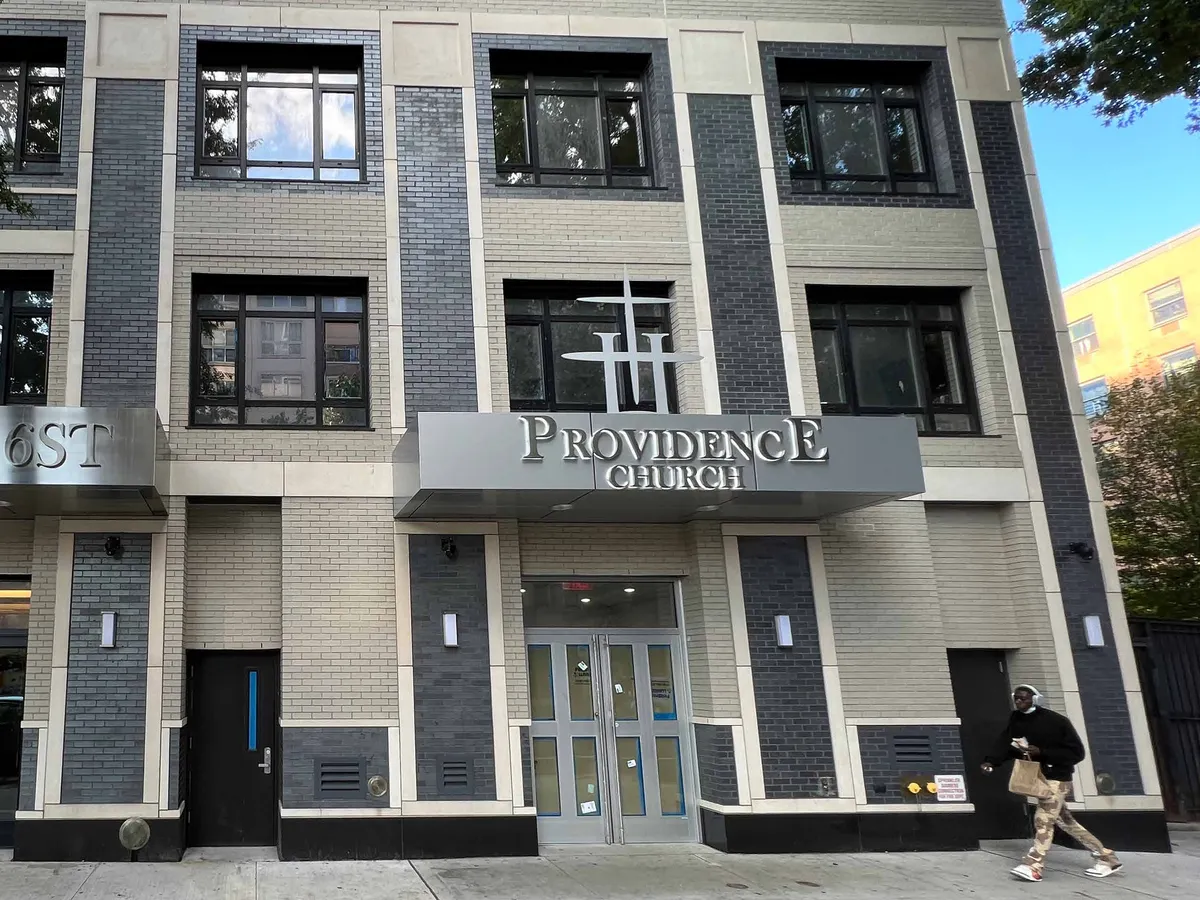 Glazed aluminum entrance doors with matching sidelights at the ground floor of a building.