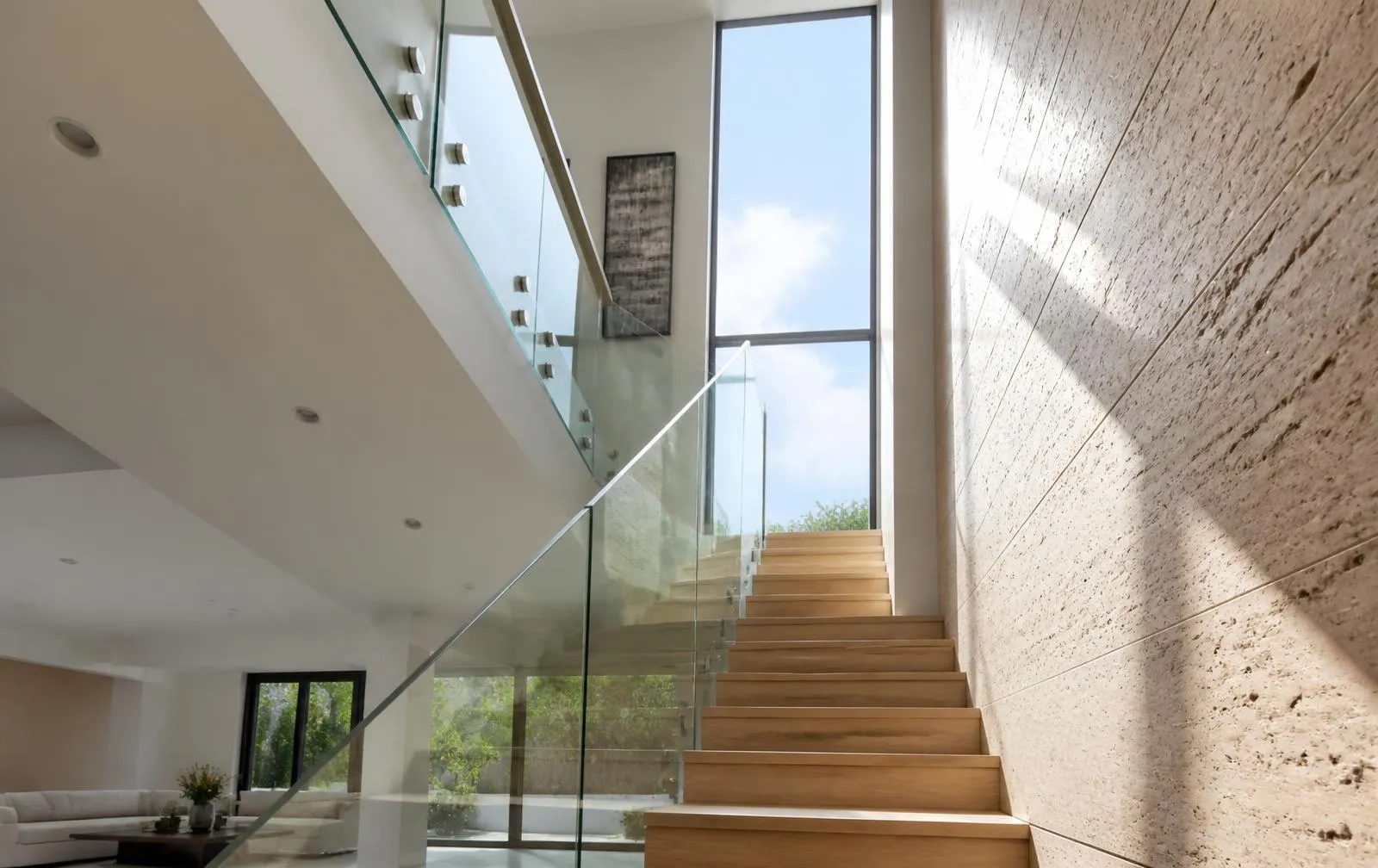 Design reference: frameless glass balustrade along a light-filled residential stair and landing